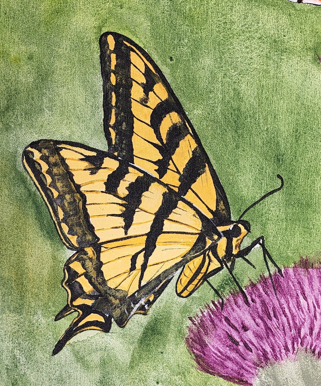 Yellow and black swallowtail butterfly perched on green leaves