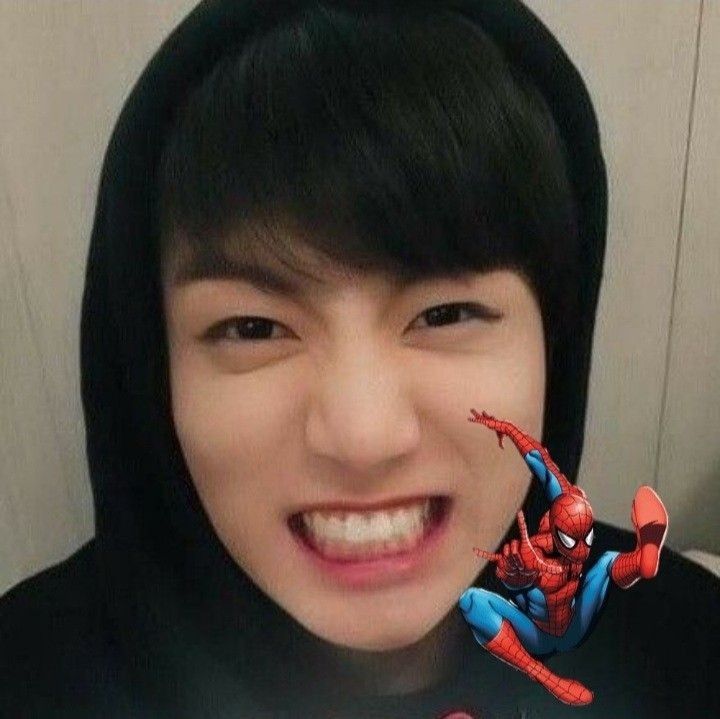 Woman with black hair smiling and holding Spider-Man figurine