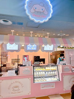 Cinnamoroll Dream Cafe interior with pink striped counter, pastel decor, and Sanrio character signage