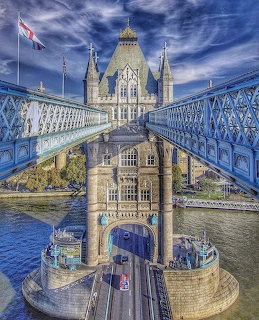 Tower Bridge in London with its distinctive twin towers and blue suspension walkways over the Thames River