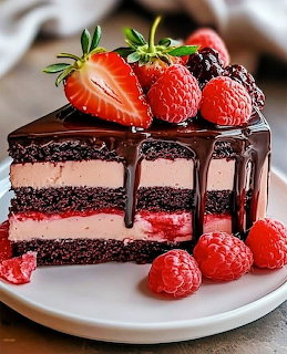 Slice of layered chocolate cake with strawberry filling topped with ganache, strawberries and raspberries