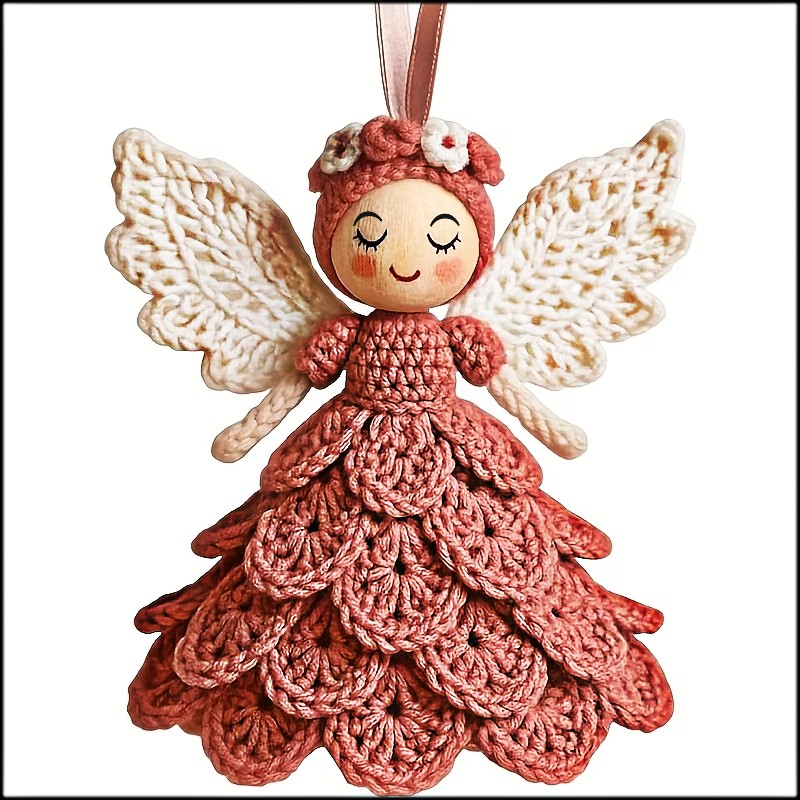 Crocheted angel ornament with a pink dress, white wings, and hanging loop on a white background