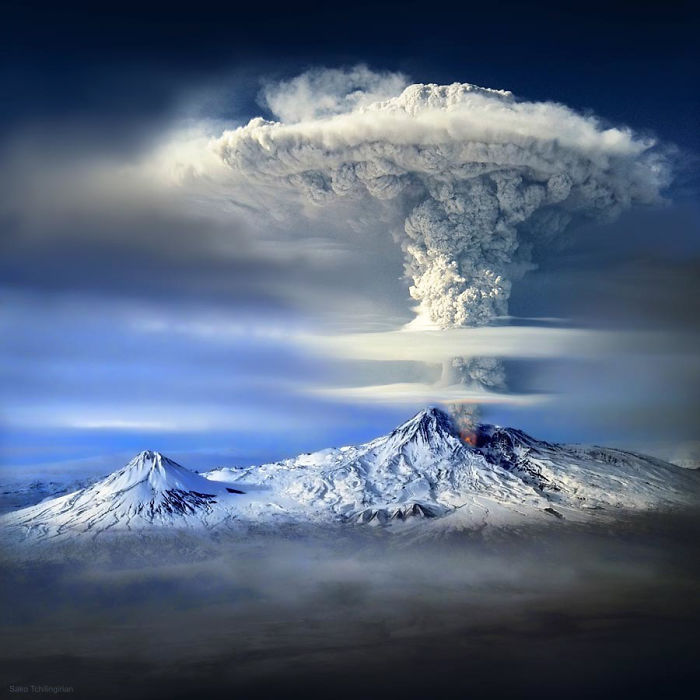 Volcanic eruption on Mount Ararat with large mushroom-shaped ash cloud above snow-covered mountain peaks