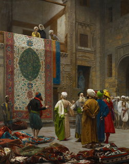 Oriental carpet merchant showing decorative rugs to robed figures in sunlit courtyard