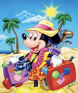 Mickey Mouse in sun hat standing with luggage on sunny tropical beach with palm trees