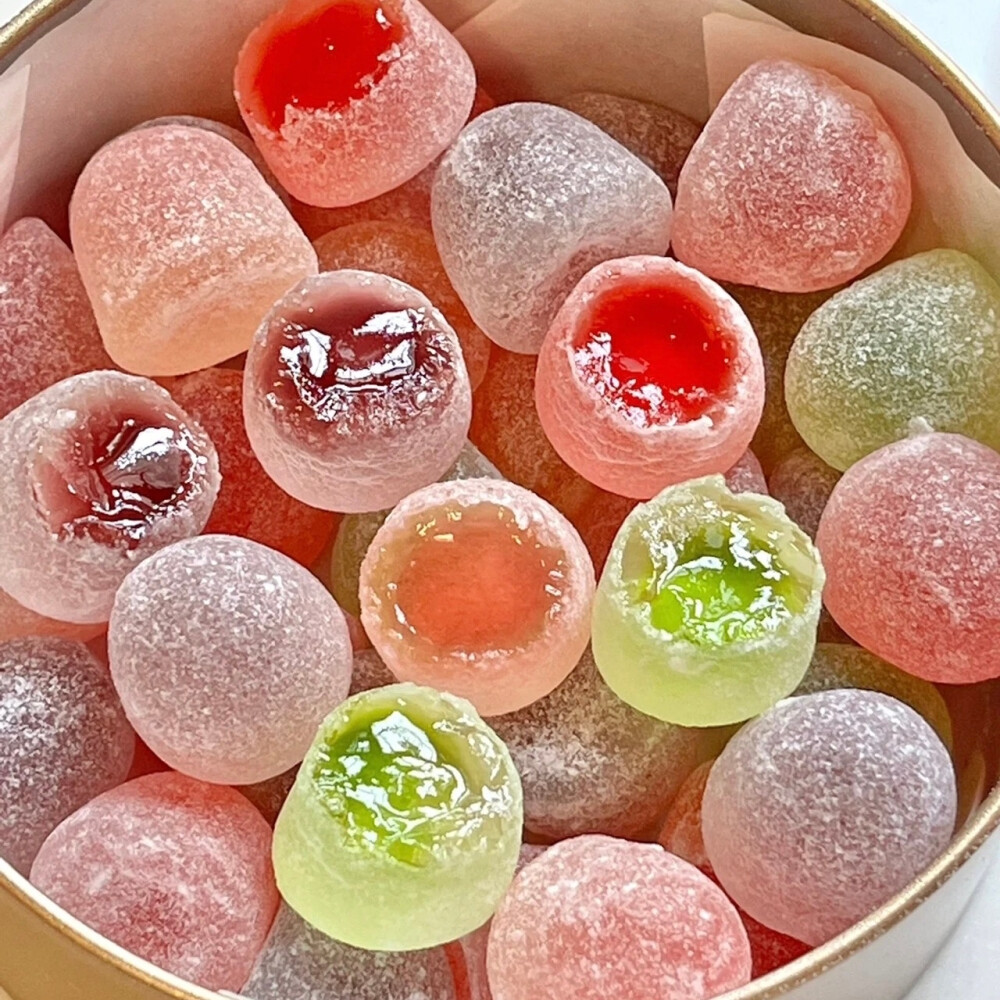 Close-up of assorted sugar-coated jelly candies in a round container