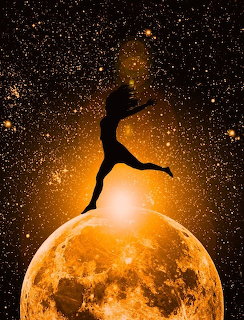 Silhouette of dancer posed on bright moon against starry space background with orange glow