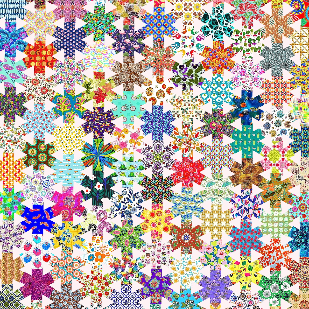 Dense colorful patchwork quilt with hexagonal fabric patches in various patterns and colors