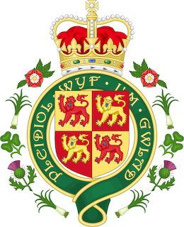 Heraldic British royal crest with crown, shield, motto belt, and floral emblems