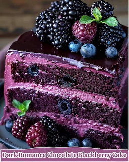 Slice of chocolate layer cake with purple frosting and fresh berries on top