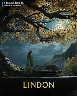 Robed figure under golden tree gazing at misty mountain landscape at dusk