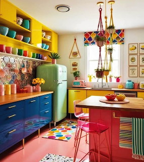 Brightly colored retro kitchen with yellow shelves, blue cabinets, green vintage fridge, and red island