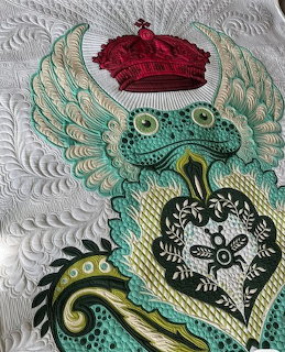 Quilted frog prince with red crown, green wings, and ornate heart design on white background