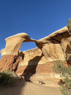 Natural sandstone rock arch against blue sky at Devils Playground near Escalante Utah