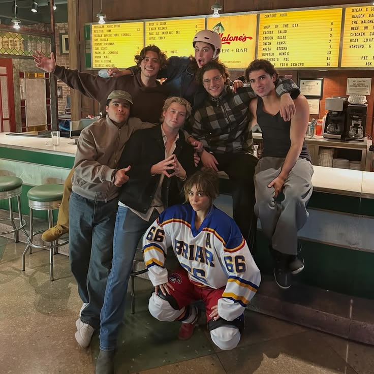 Group of young friends posing together inside a diner near the counter