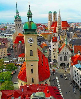 Aerial view of Munich with church towers, red roofs, and historic buildings in Bavaria
