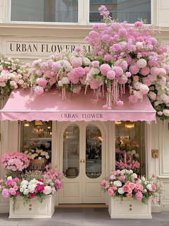 Flower shop storefront covered in pink floral arrangements with a pink awning and bouquets at the entrance