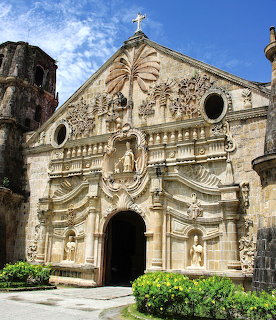 Baroque stone facade of Miag-ao Church in Iloilo, Philippines, with carved reliefs and arched entrance
