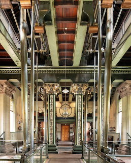 Interior of a Victorian pumping station with ornate iron columns and metal machinery