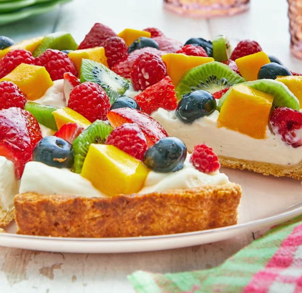 Fruit tart with berries, kiwi, and mango on cream filling