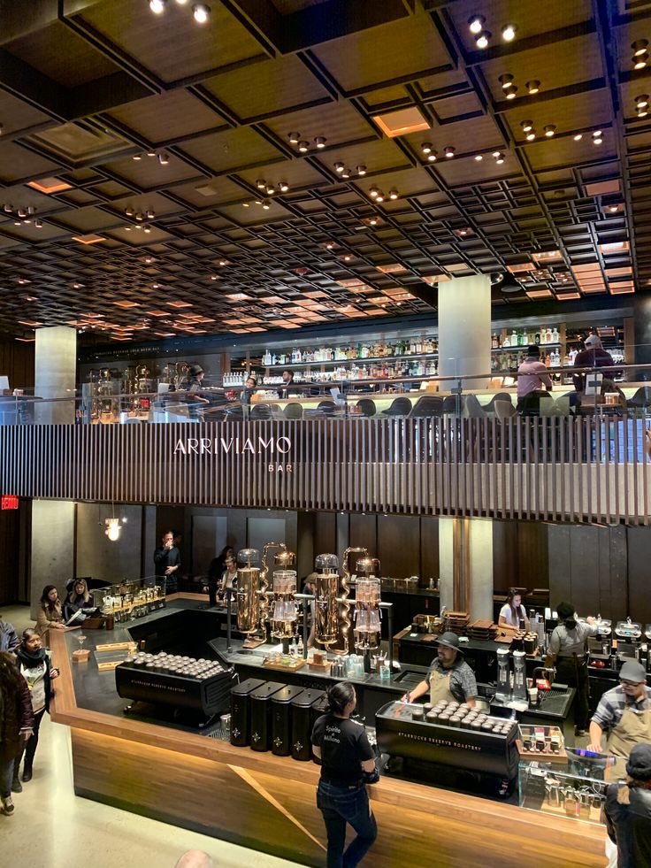 Interior of a large two-story coffee roastery with copper ceiling, bar, and product displays