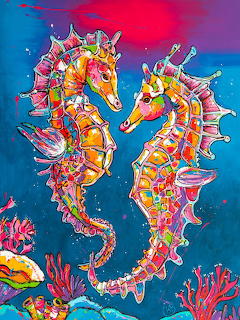 Two brightly colored seahorses in rainbow hues facing each other underwater with coral