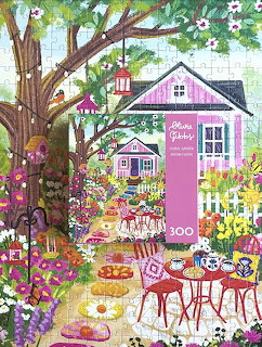 Colorful illustrated garden cafe beside a pink cottage with flowers, trees, and outdoor tables
