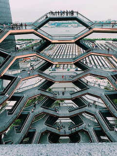 Upward angle of The Vessel sculpture at Hudson Yards showing stacked hexagonal platforms and copper metallic finish