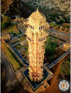 Aerial view of the Vijay Stambha tower at Chittorgarh Fort, India, bathed in golden sunlight