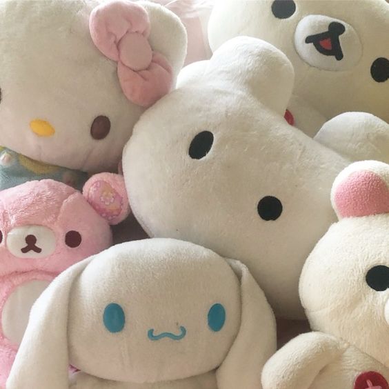 Close-up of pastel plush toy characters including Hello Kitty and other stuffed animals