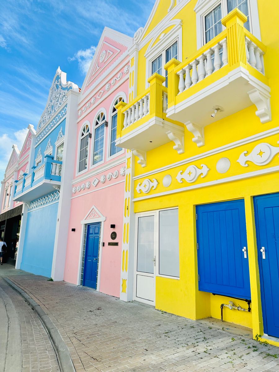 Row of brightly colored colonial buildings with balconies in Aruba