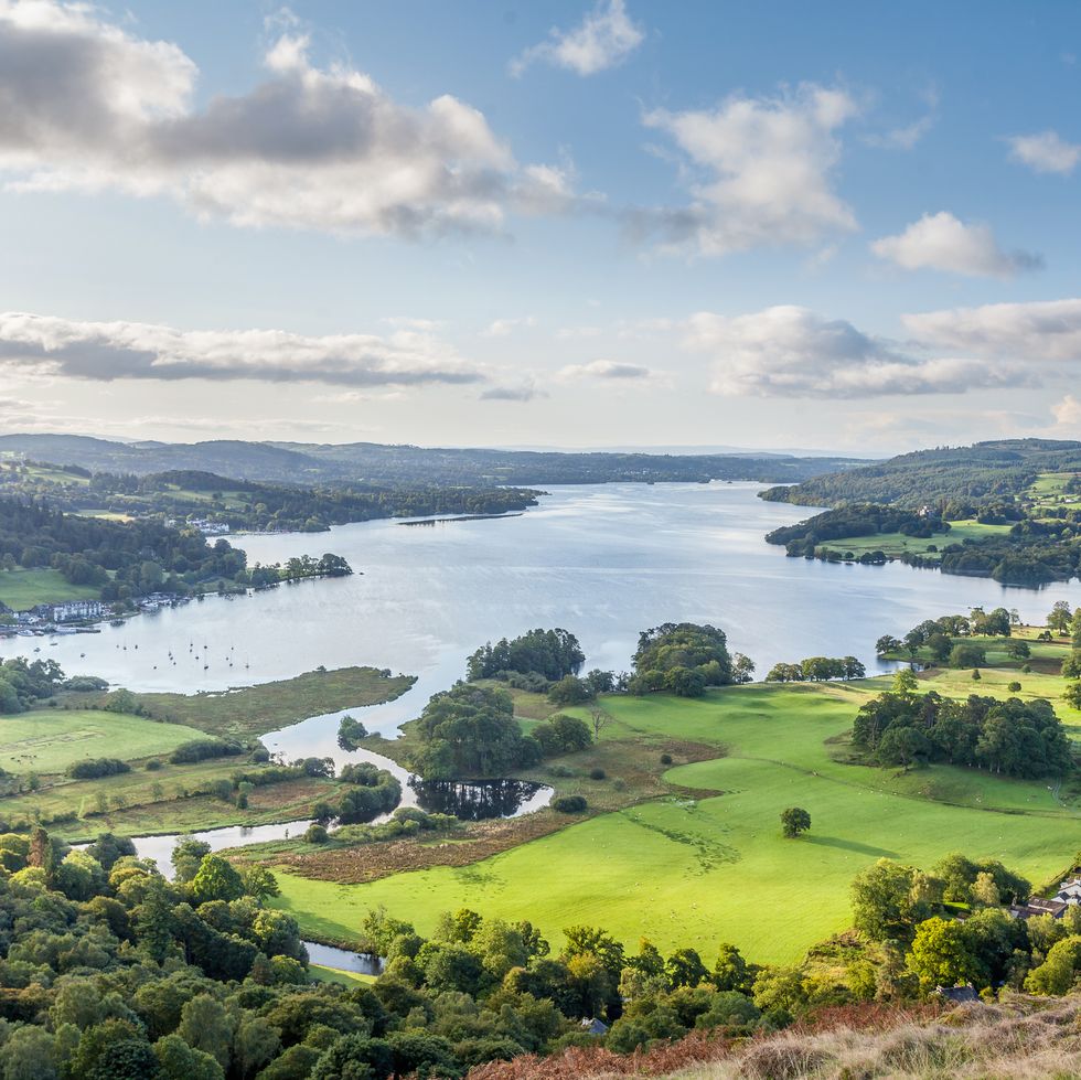 Scenic aerial view of Lake Windermere surrounded by rolling green hills and fields in the English Lake District