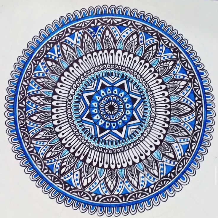 Detailed blue and white mandala with symmetrical geometric and floral patterns in concentric circles