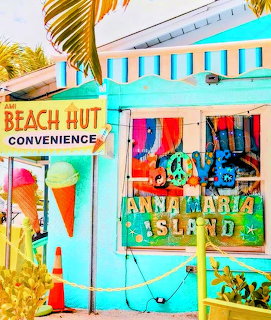 Colorful turquoise beach hut convenience store with Anna Maria Island sign and ice cream decoration