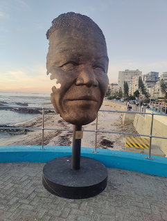 Bronze sculpture bust of Nelson Mandela on pedestal at Sea Point with ocean view