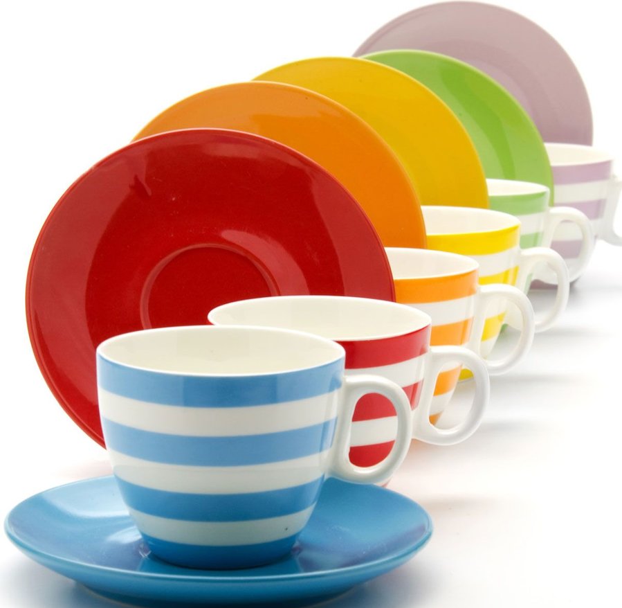 Row of colorful striped teacups with saucers arranged in rainbow order from blue to pink