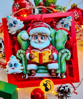 Christmas cookies shaped like Santa in sleigh with polar bears on red tray surrounded by ornaments