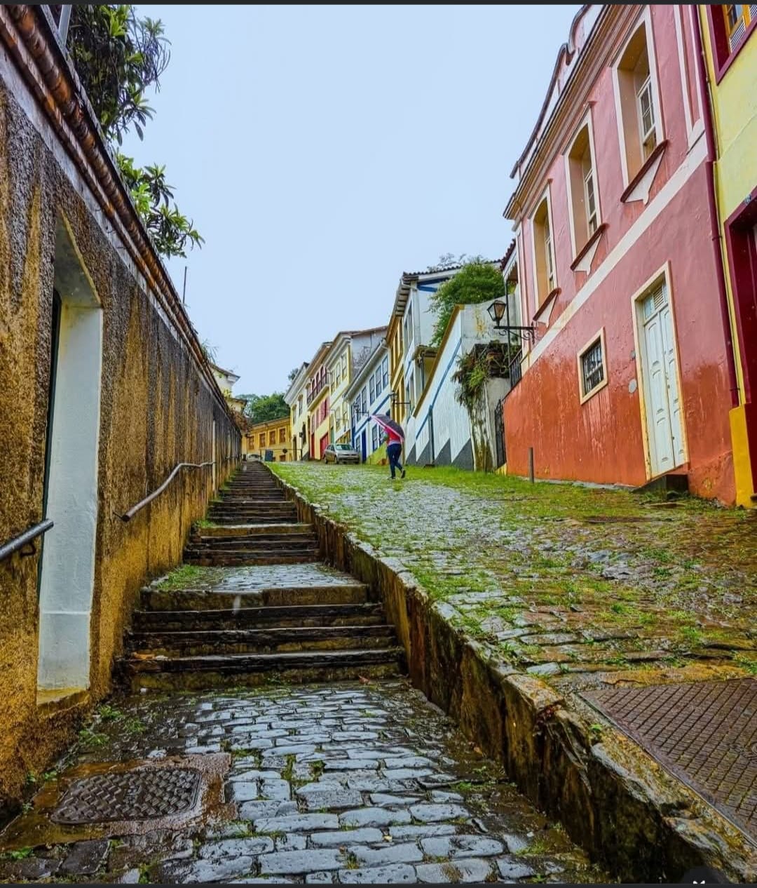Cobblestone colonial street with colorful buildings and stone steps in Minas Gerais, Brazil
