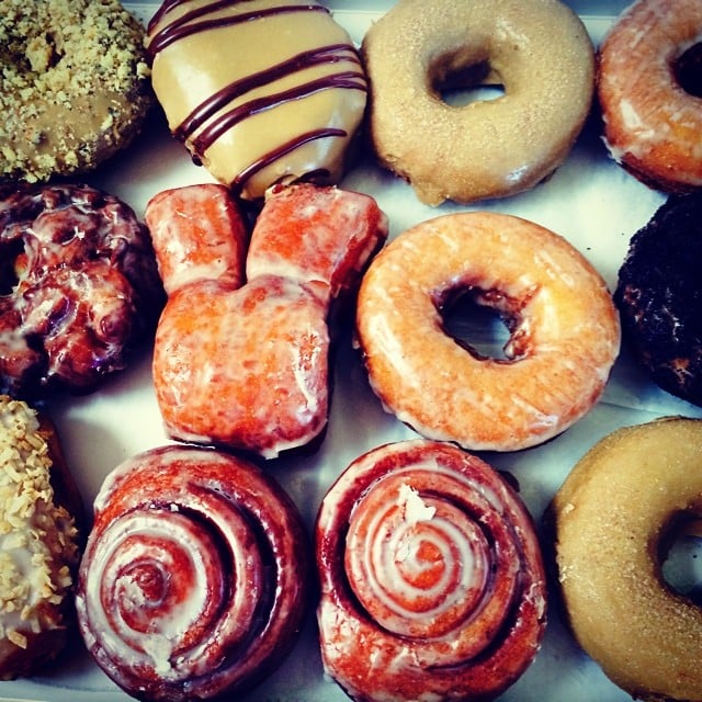 Assortment of colorful donuts with various glazes and toppings arranged together