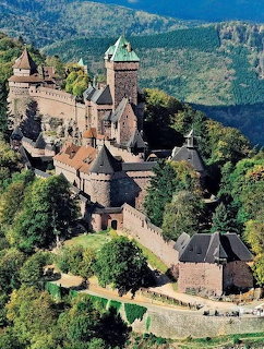 Medieval castle with towers on forested mountain in Alsace, France