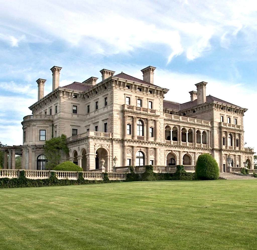 Large Renaissance Revival mansion with ornate architecture and green lawn