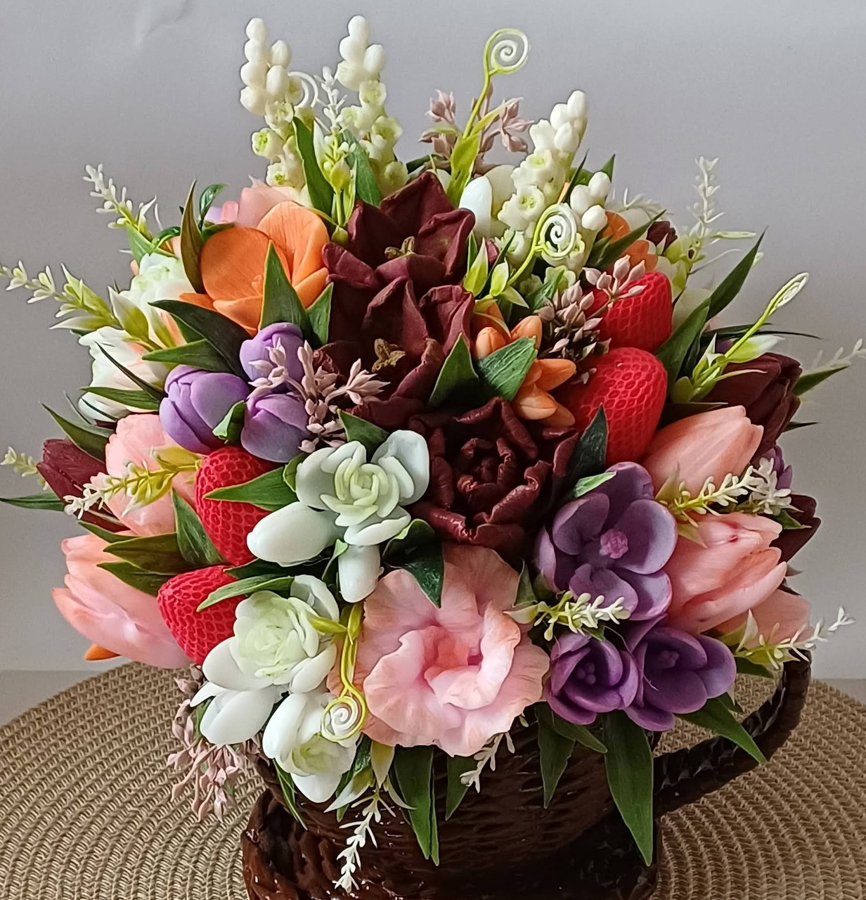 Colorful artificial flower bouquet with tulips, roses, and mixed blooms in pink, purple, orange, and burgundy