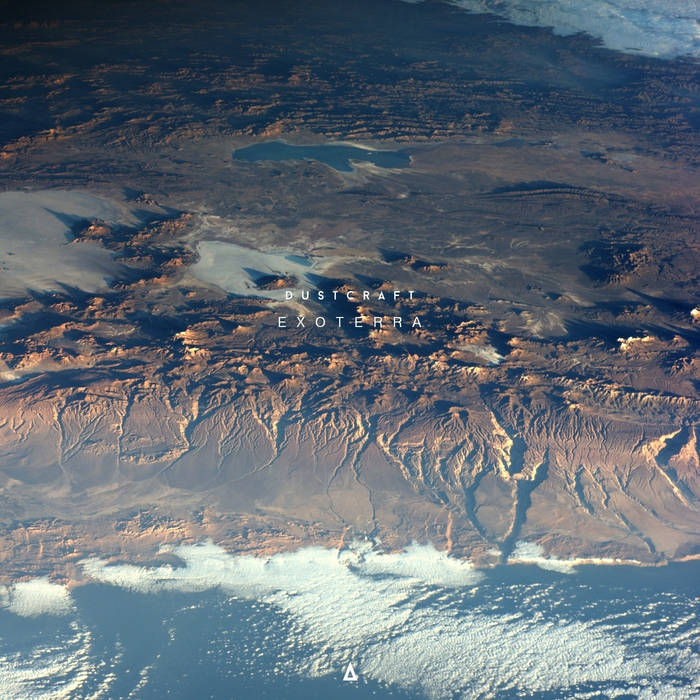 Aerial view of a desert mountain landscape with scattered clouds