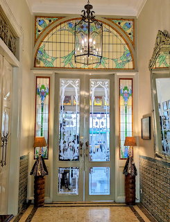 Art Nouveau entrance hall with stained glass windows and chandelier