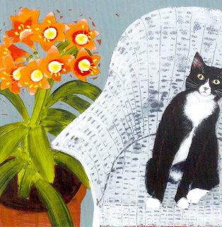 Black and white tuxedo cat sitting on white wicker chair next to orange clivia flowers in terracotta pot