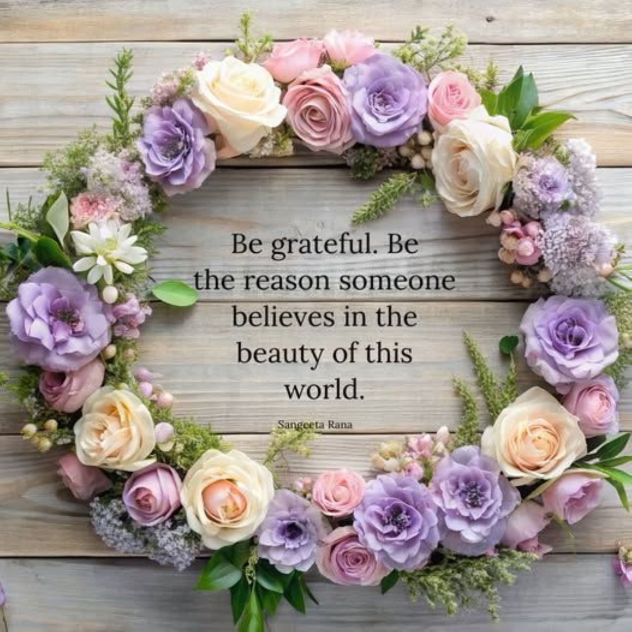 Circular flower wreath with purple, pink, and cream roses around a Be Grateful inspirational quote on wooden planks