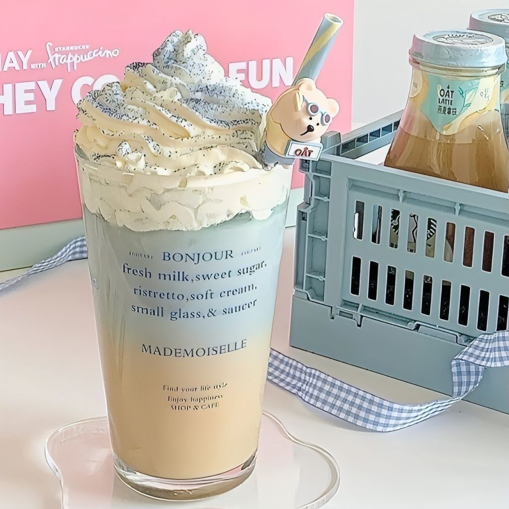 Iced milk tea with whipped cream in a clear cup beside a bottled drink in a small crate