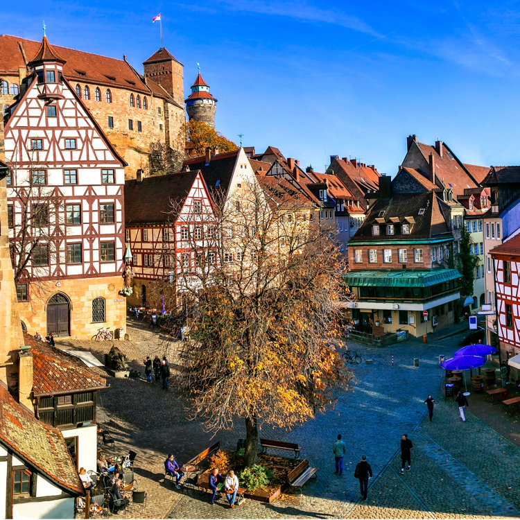 Medieval castle and half-timbered buildings along river in Nuremberg, Germany