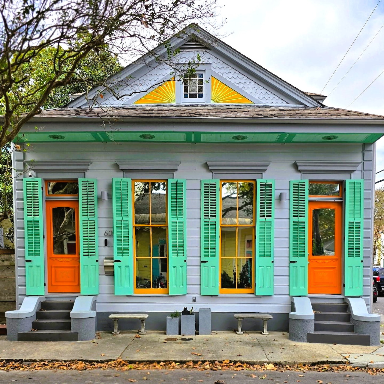 Turquoise house with orange doors and yellow window frames
