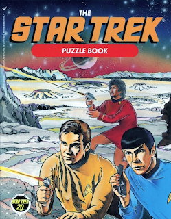 Illustrated Star Trek puzzle book cover showing Kirk, Spock, and Uhura on a rocky alien landscape with the Enterprise